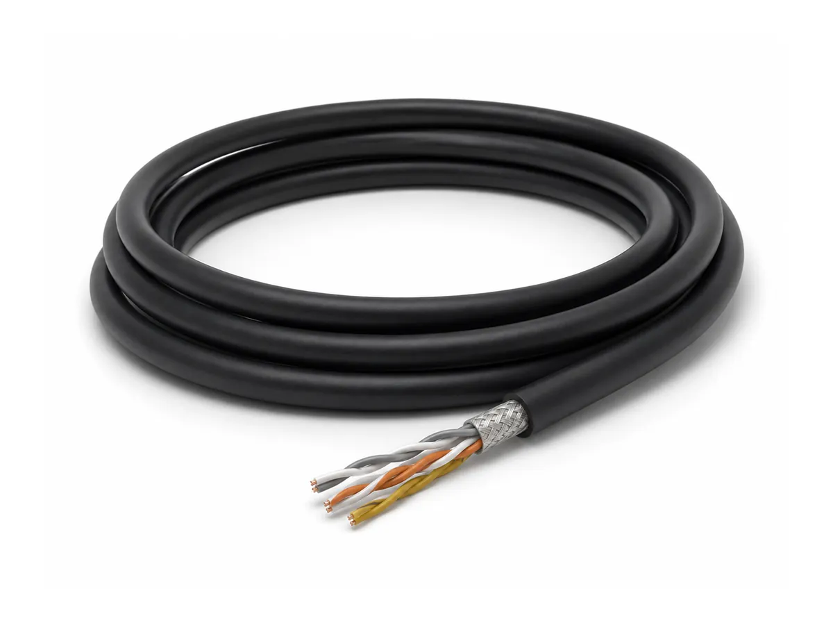Coiled high-speed drag chain data cable on white background
